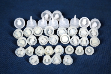 Pharmaceutical plastic stoppers